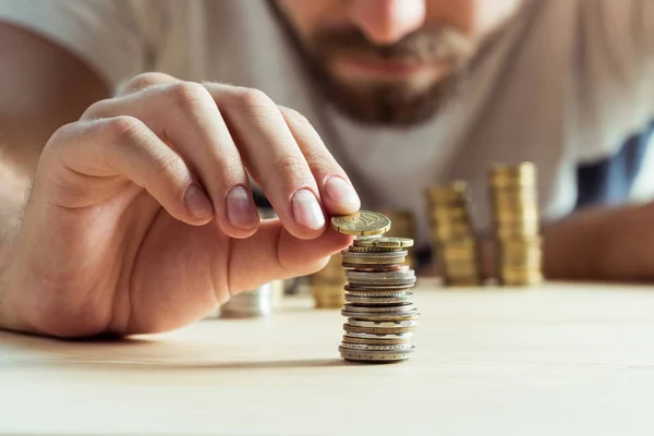 depositphotos_161657882-stock-photo-man-stacking-coins